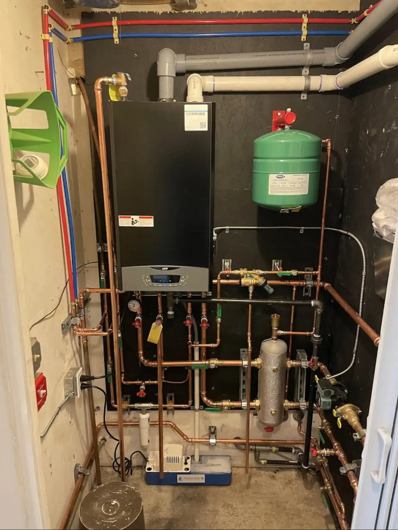 Wall-mounted boiler with copper piping and expansion tank