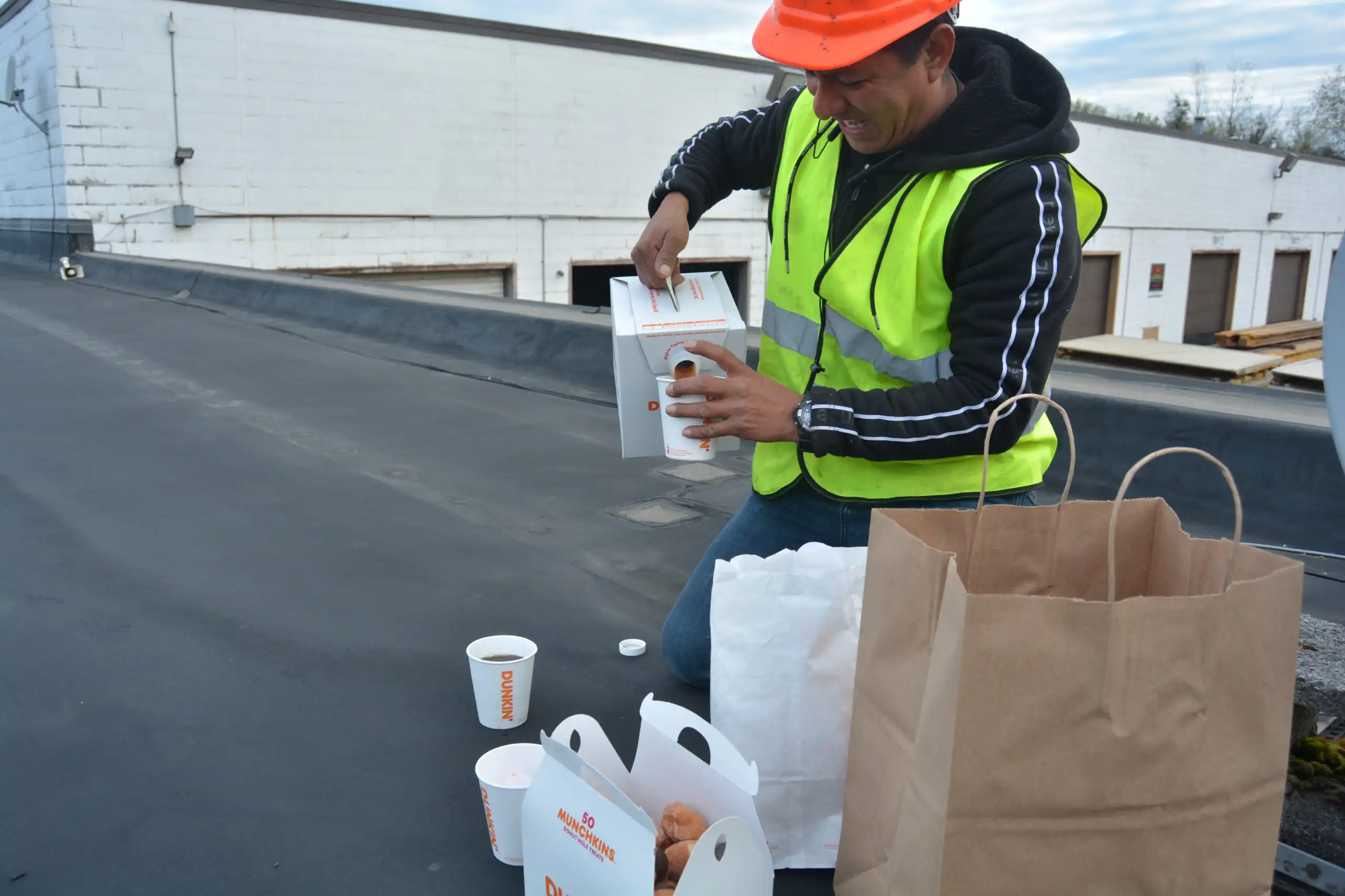 Volpe technician taking a break on a rooftop job site