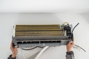 Installation air conditioning system in room with white wall in apartment, office closeup